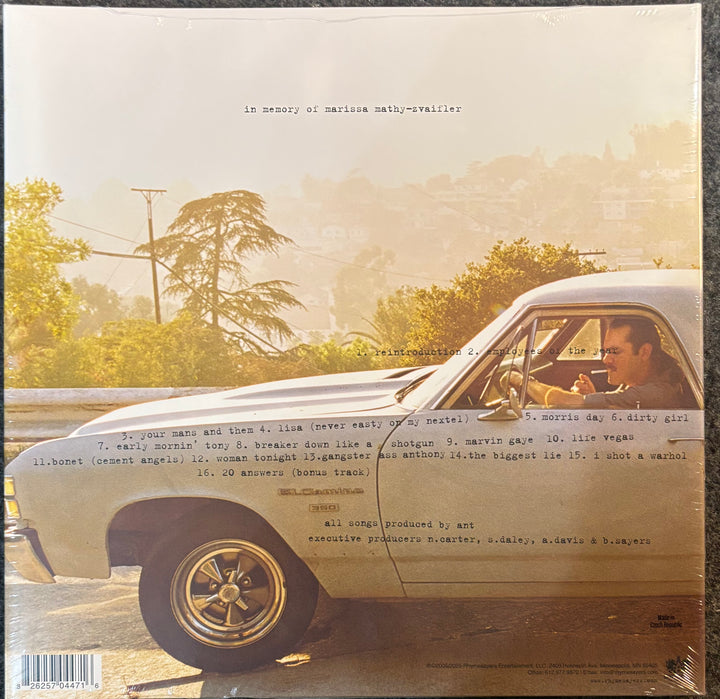 The back cover of the album Felt – Felt 2: A Tribute To Lisa Bonet, featuring a vintage car on a road with a driver visible in the window, photographed against a dark background.