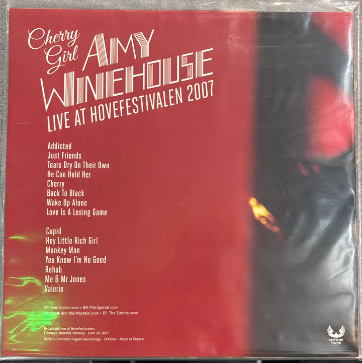 Album cover for Amy Winehouse's live performance at Hovefestivalen 2007 with a red background and black and white image of a person.