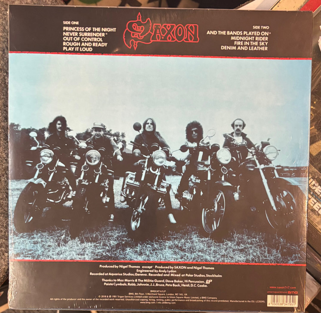SAXON - Denim And Leather record cover with a band on motorcycles and Saxon logo.