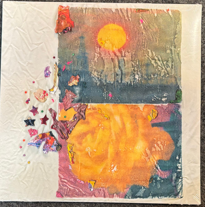Burs – Significance, Otherness, featuring a large yellow sun over a dark blue and orange landscape with colorful star-like embellishments on the left, photographed on a dark textured surface.