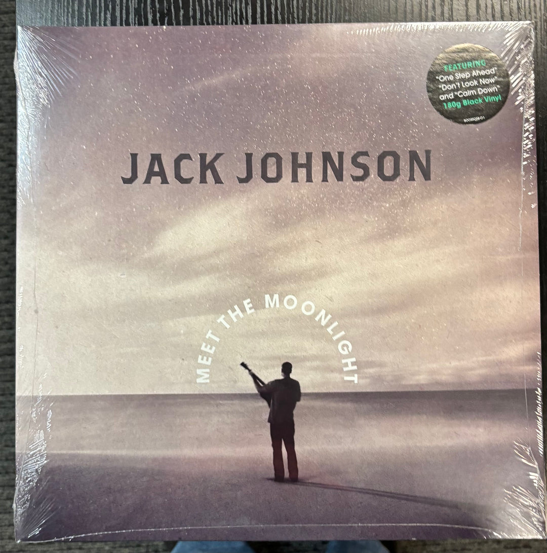 Album cover of 'Meet the Moonlight' by Jack Johnson with a person standing on a beach.