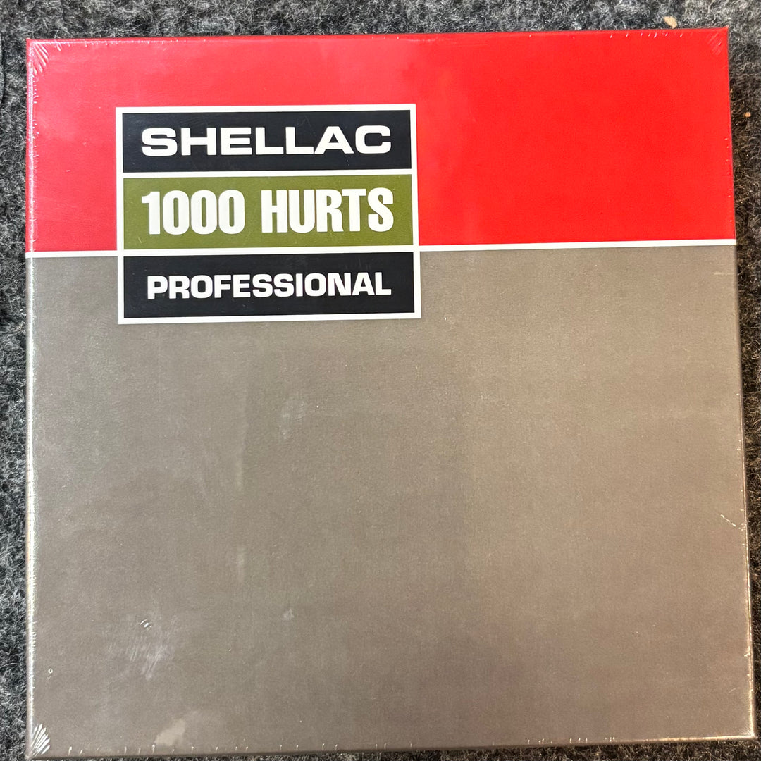  'Shellac 1000 Hurts Professional' CD label on a textured surface