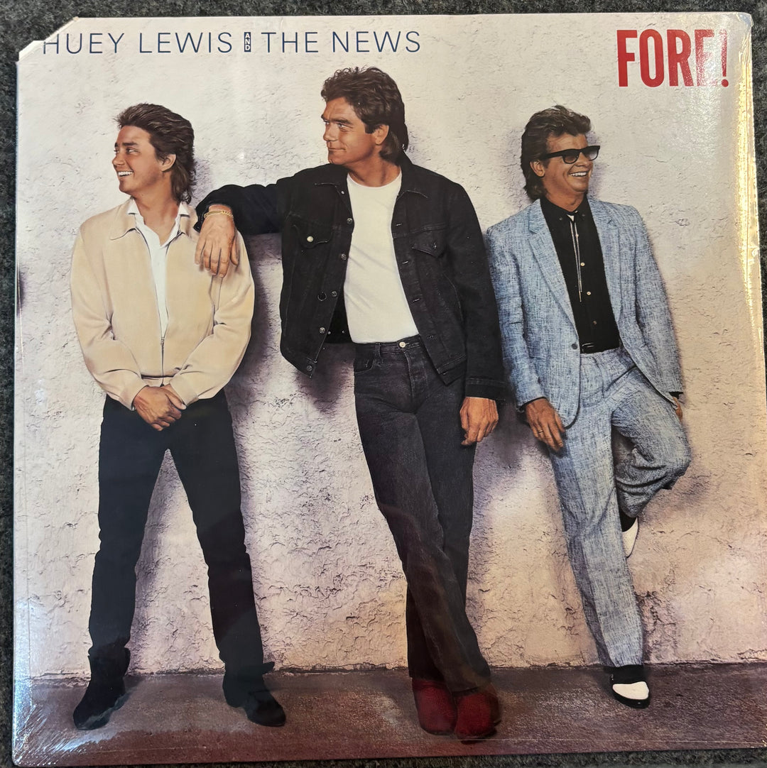 Album cover of 'Fore!' by Huey Lewis and the News featuring three men posing against a textured wall.