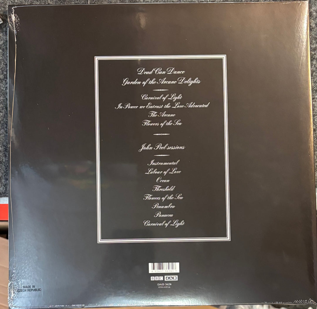 Back cover of Dead Can Dance - Garden Of The Arcane Delights/Peel Sessions with text and a barcode on a reflective surface