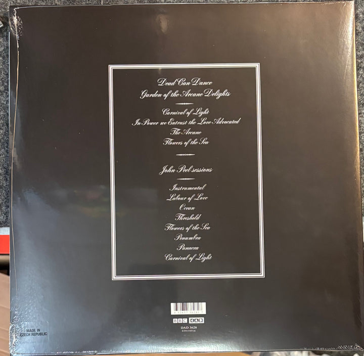 Back cover of Dead Can Dance - Garden Of The Arcane Delights/Peel Sessions with text and a barcode on a reflective surface