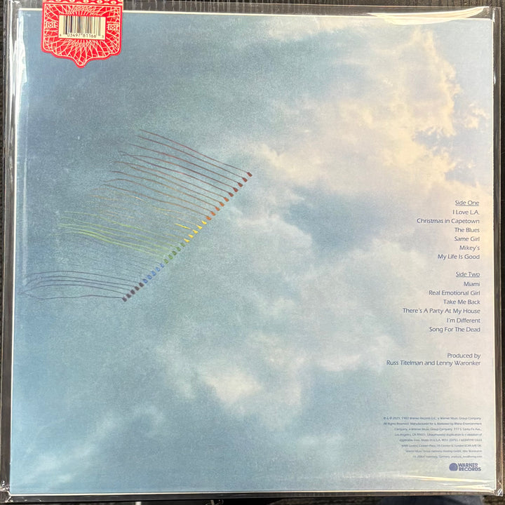 NEWMAN, RANDY – TROUBLE IN PARADISE record cover with cloud design and text on a blue background