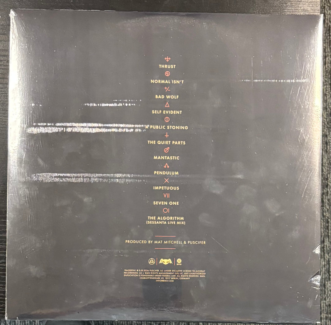 Back cover of PUSCIFER ‎– NORMAL ISN'T with tracklist and production credits.