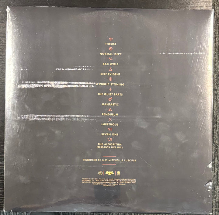 Back cover of PUSCIFER ‎– NORMAL ISN'T with tracklist and production credits.