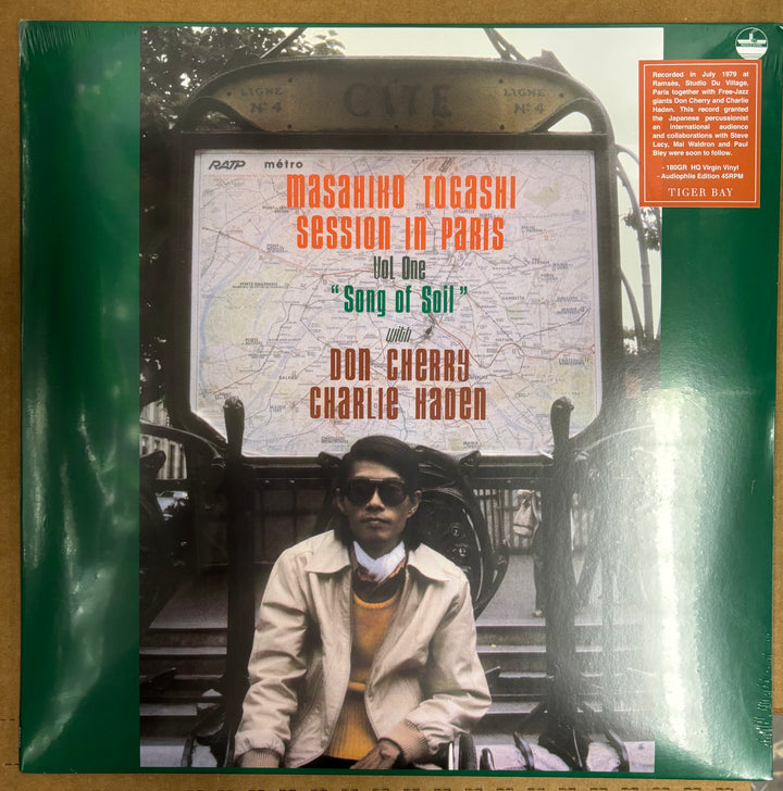 Vinyl record cover with a person sitting in front of a map, featuring text about Masahiko Togashi Session in Paris.