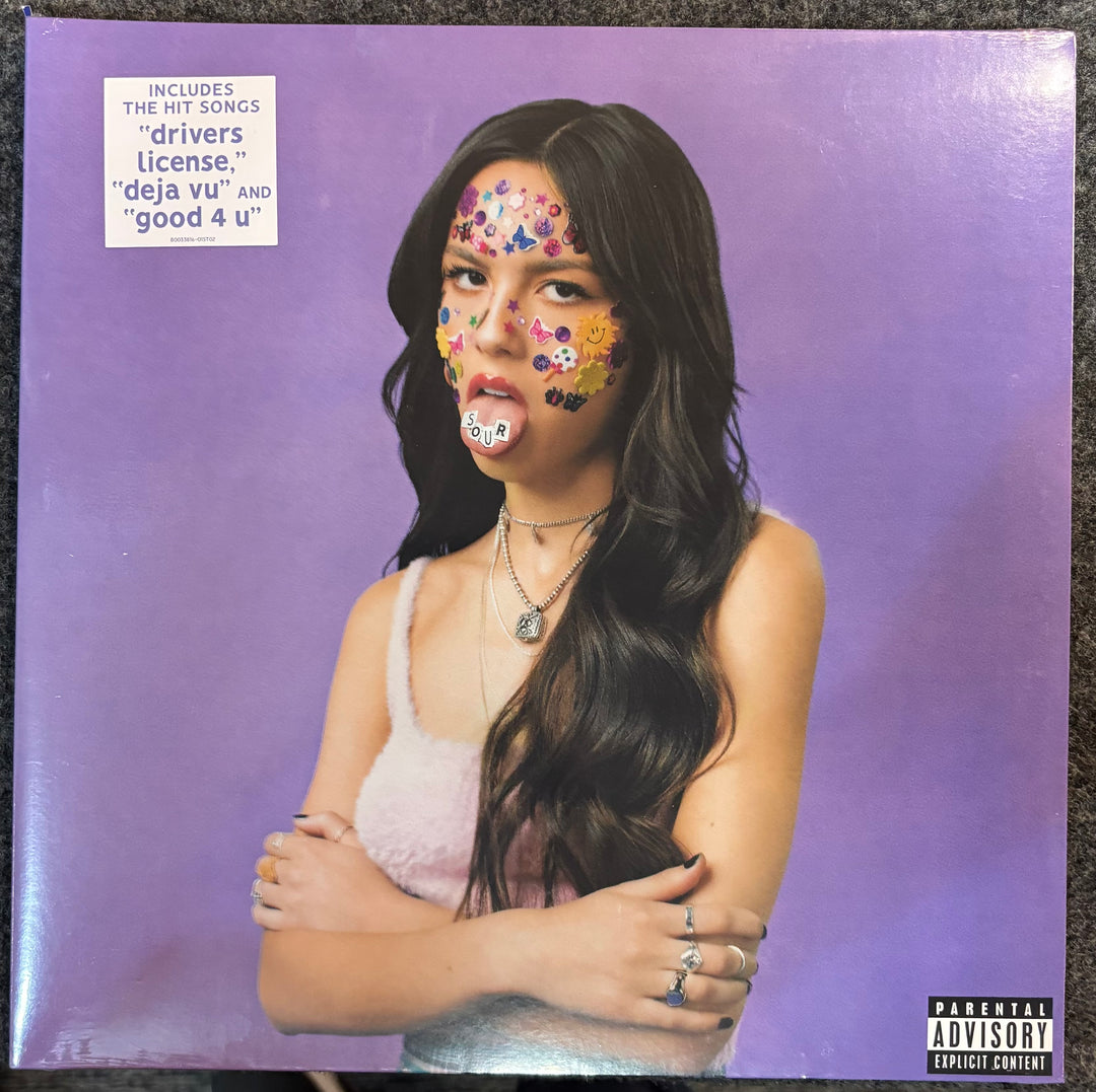 RODRIGO, OLIVIA – SOUR cover with a person with face paint against a purple background