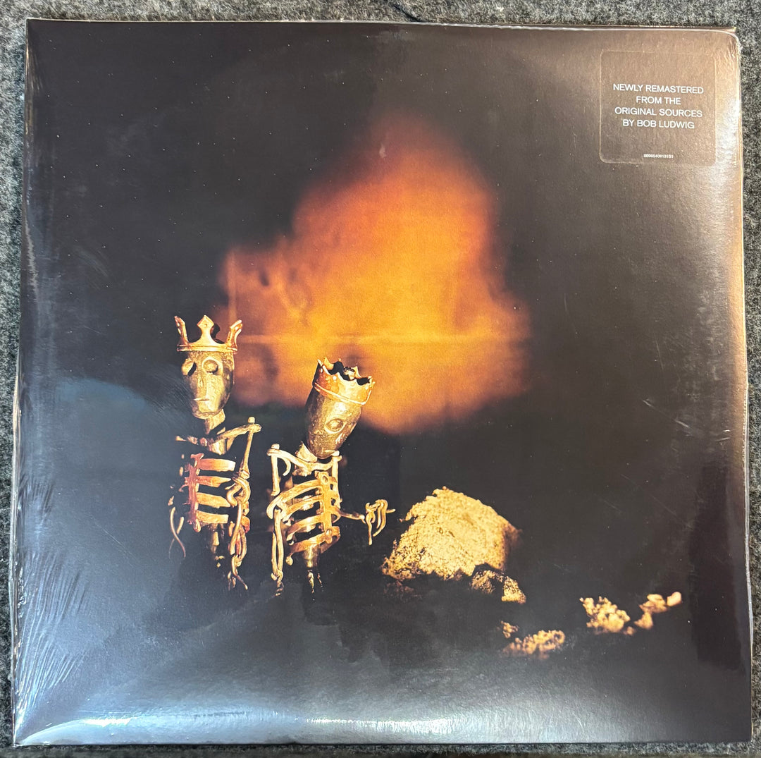 Pearl Jam – Riot Act record cover with skeletons wearing crowns and a fiery background