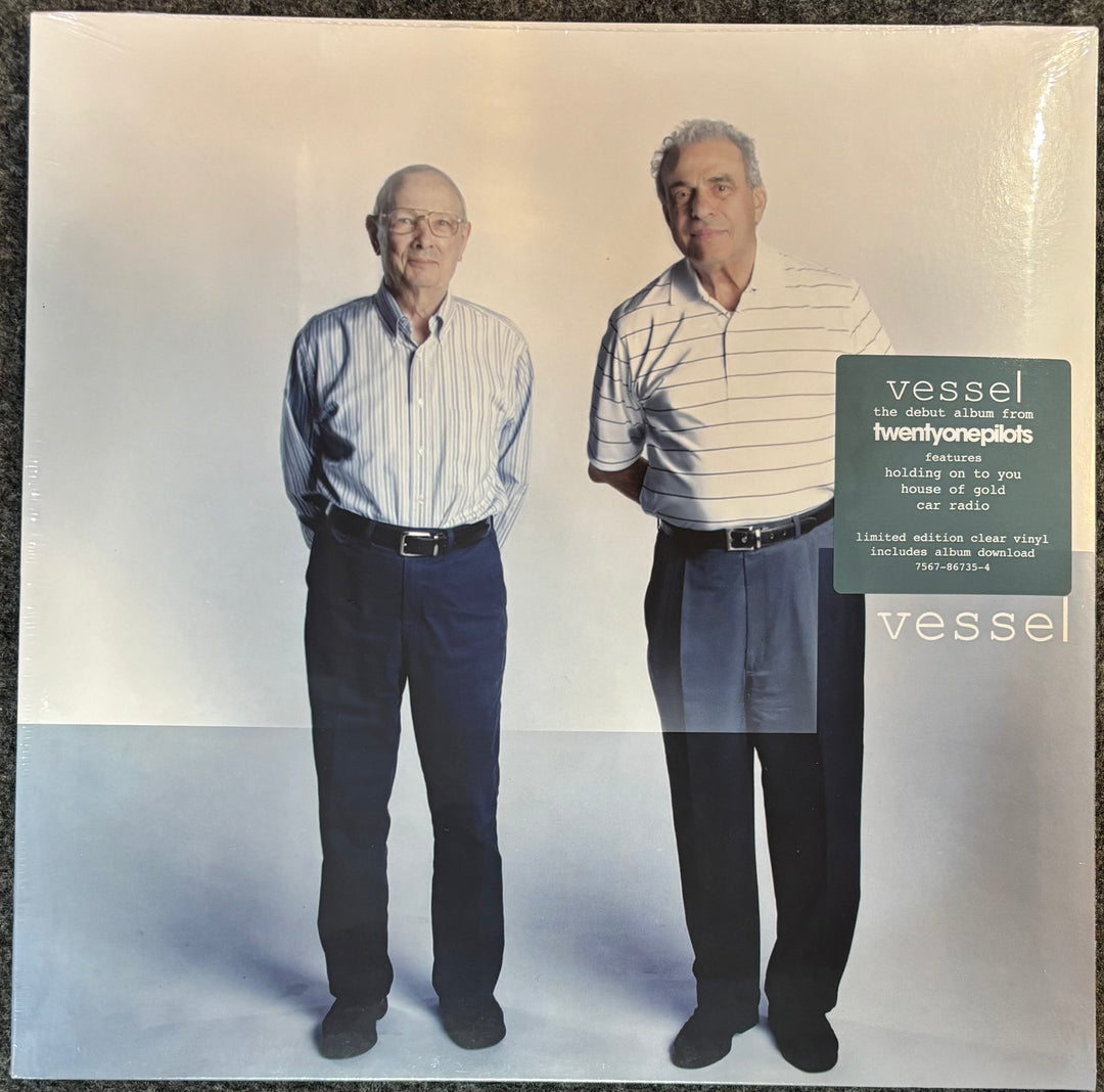 TWENTY ONE PILOTS – VESSEL cover featuring two men standing side by side with text about 'vessel' by twentyone pilots.