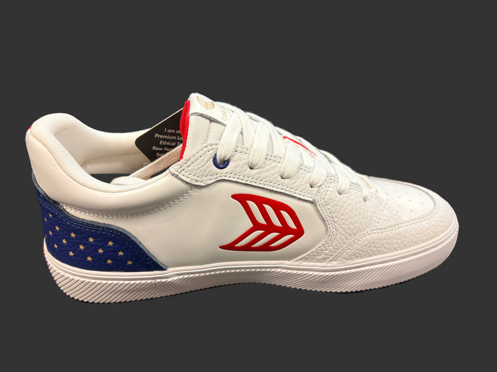 White sneaker with red and blue design on a black surface