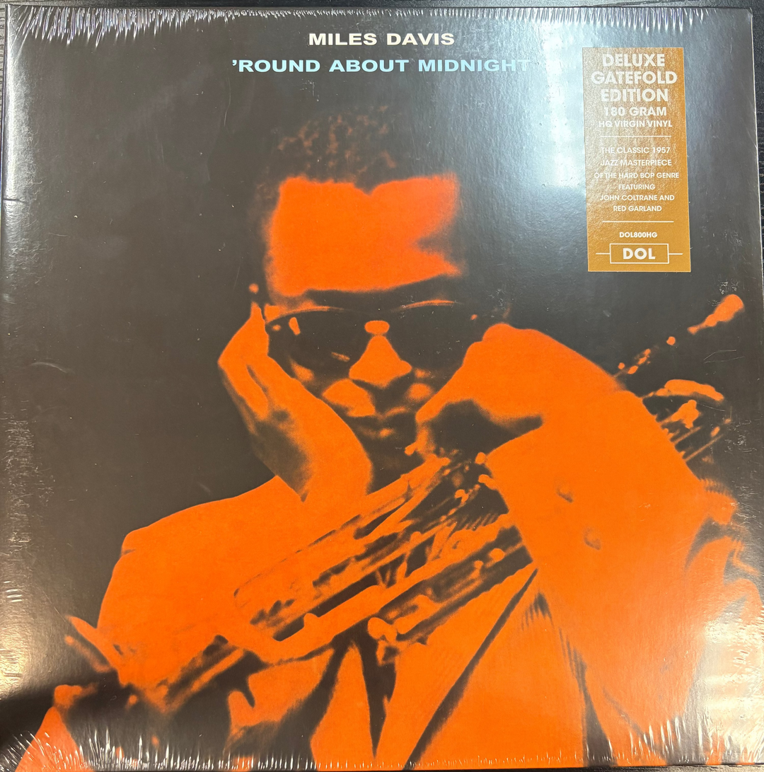 Vinyl record cover of 'Round About Midnight by Miles Davis with orange and black design.