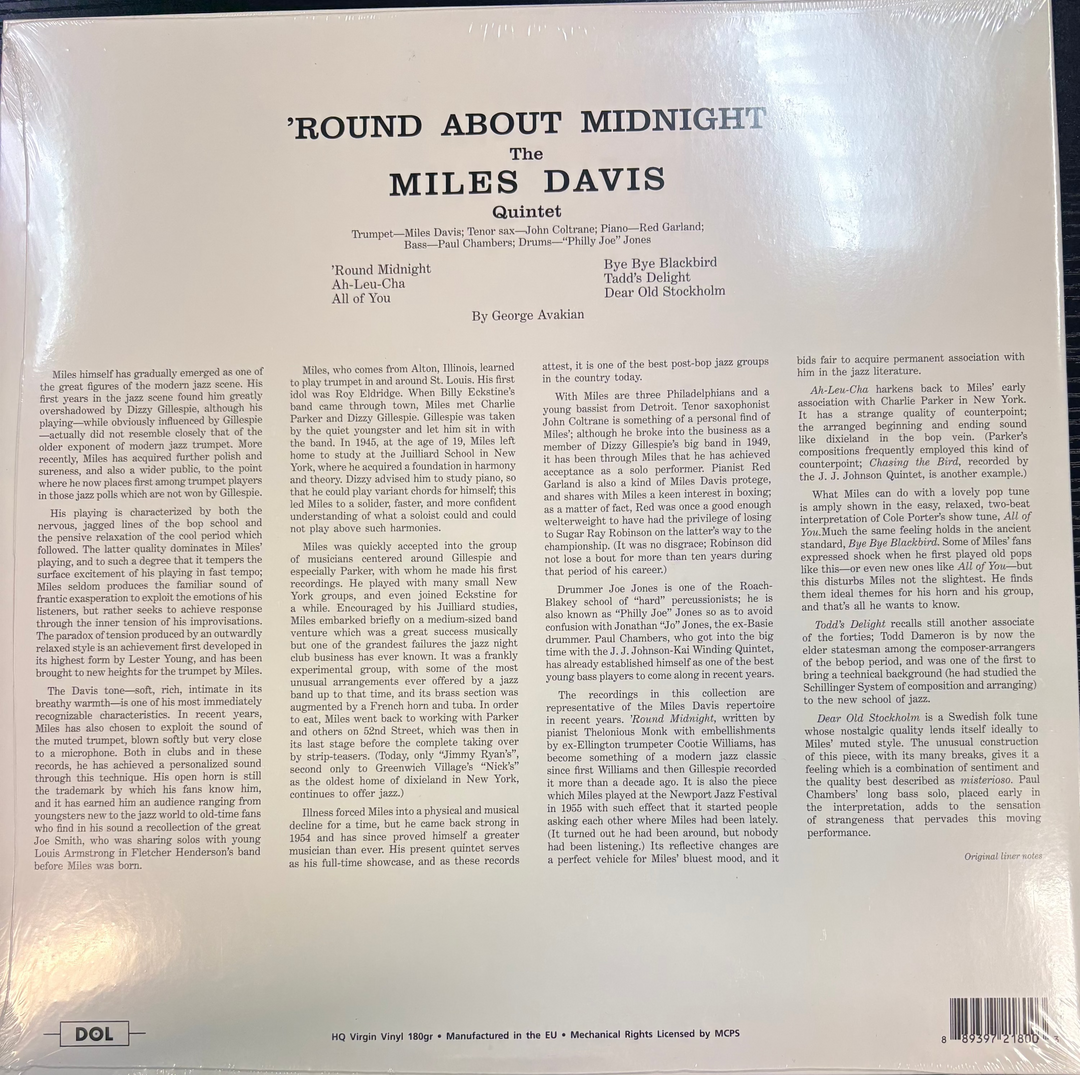 Back cover of a Miles Davis album with text and a blue patterned chair.
