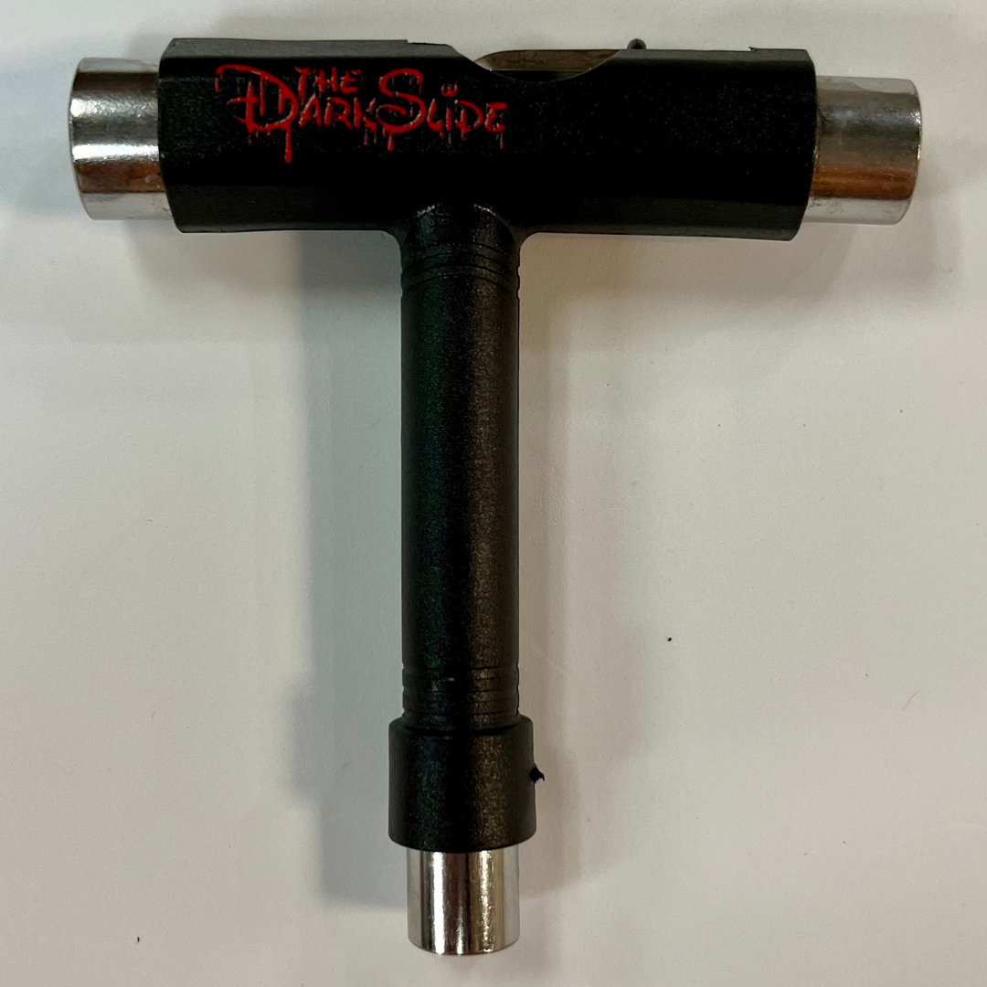 The Dark Slide "Mouse Blood" black T-shaped skateboard tool with sockets for different skateboard parts and Allen and Phillips wrenches. 