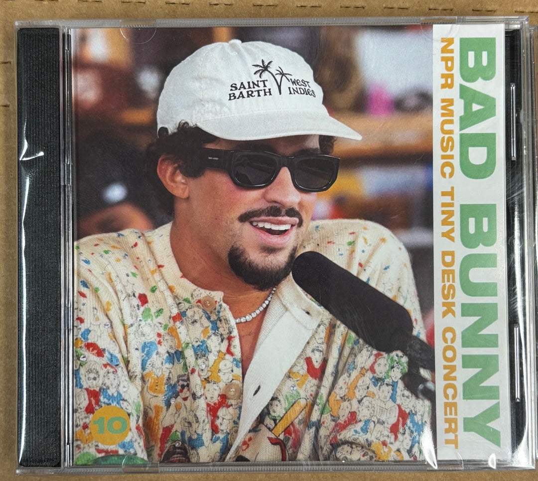 CD cover with a person wearing sunglasses and a white cap, featuring text about a NPR Music Tiny Desk Concert.