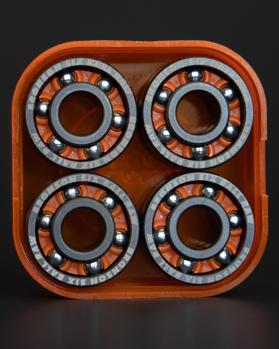 Open orange Bronson Six Ball RAW case showing the bearings inside.