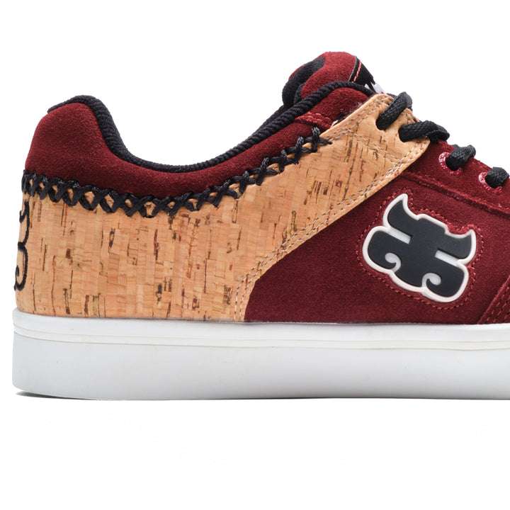 Close-up of the iPath Reed Low wine suede and cork shoe, showing the cork panel, collar stitching and side logo.