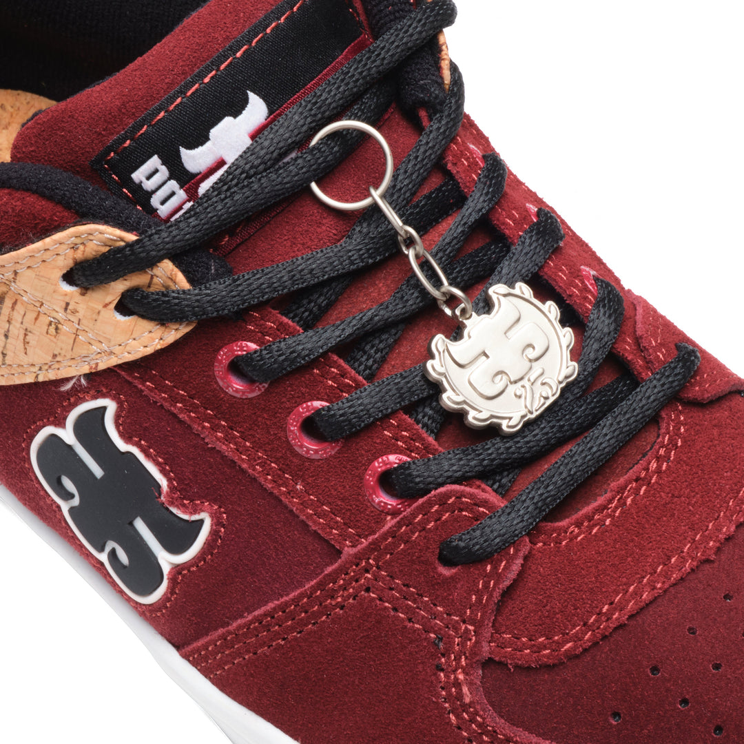 Close-up of the iPath Reed Low wine suede and cork shoe, showing laces, the tongue label and a metal logo keychain.