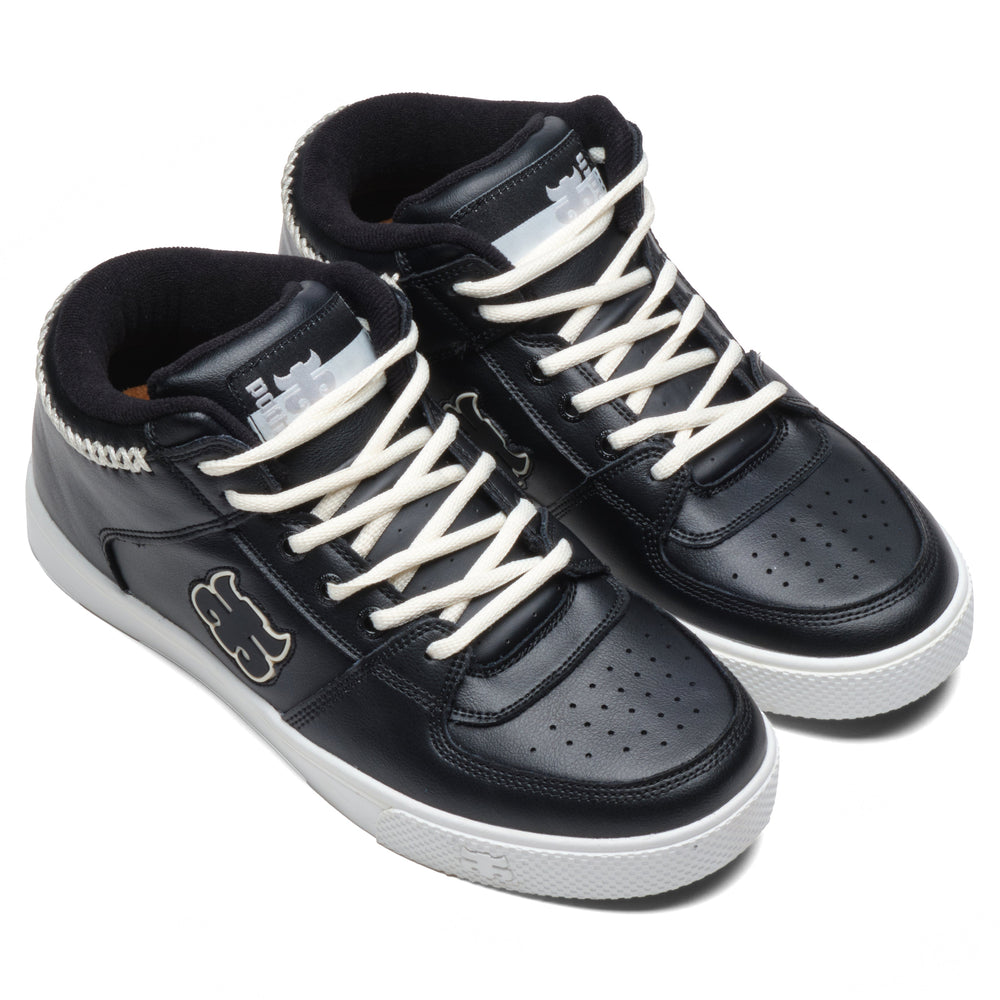 Front three-quarter view of a pair of iPath Reed Mid black leather shoes with cream laces and white soles.