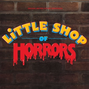 Album cover for 'Little Shop of Horrors' with colorful text on a brick background