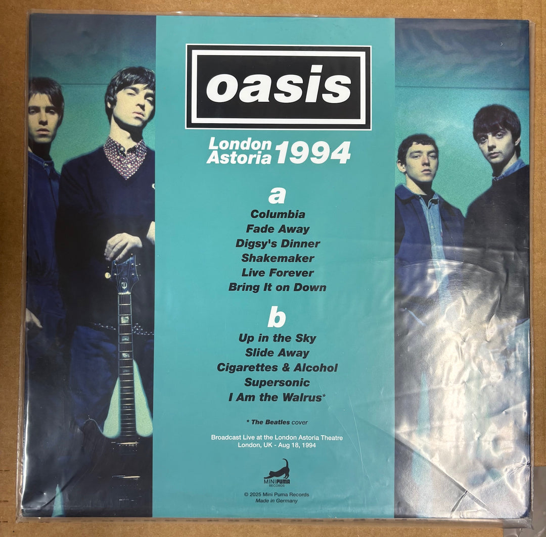 Vinyl record cover with Oasis band members and album tracklist on a teal background