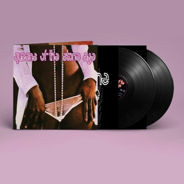 Vinyl record with cover featuring 'Queens of the Stone Age' on a purple background