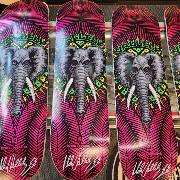 MIke Vallely Signed skateboard decks with elephant design on a patterned surface