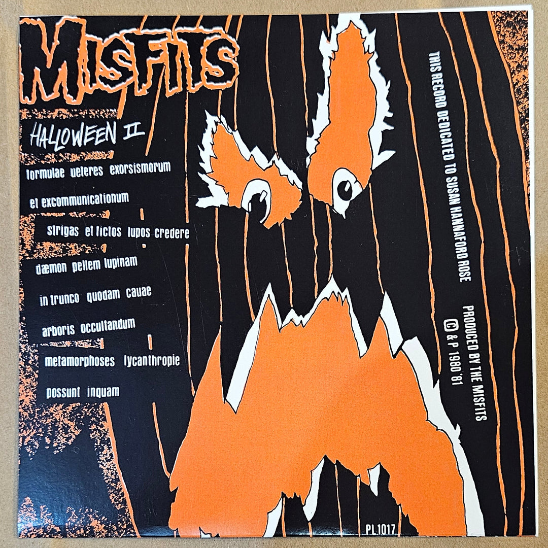 Vinyl record cover with orange and black design on a textured beige background