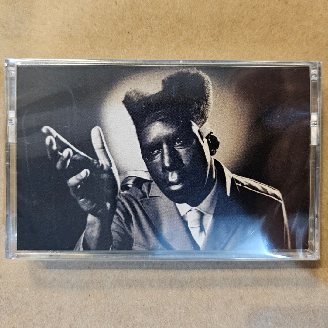 Cassette tape with a black and white photo of a person wearing a fur hat on a beige background