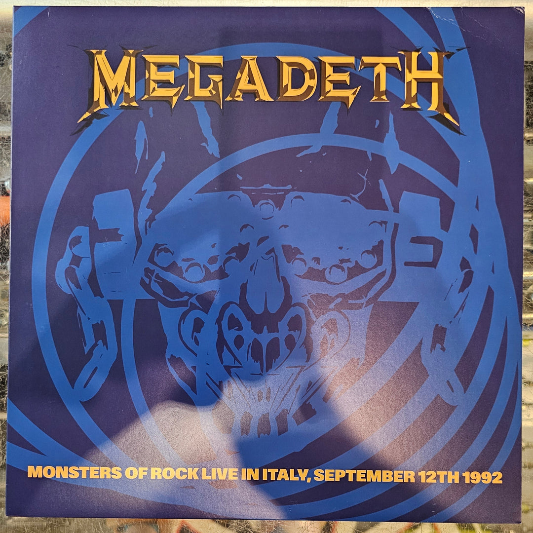 Megadeth album cover with blue tiger design and text on a reflective surface