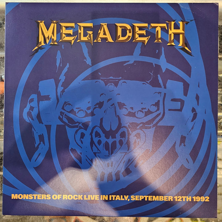Megadeth album cover with blue tiger design and text on a reflective surface