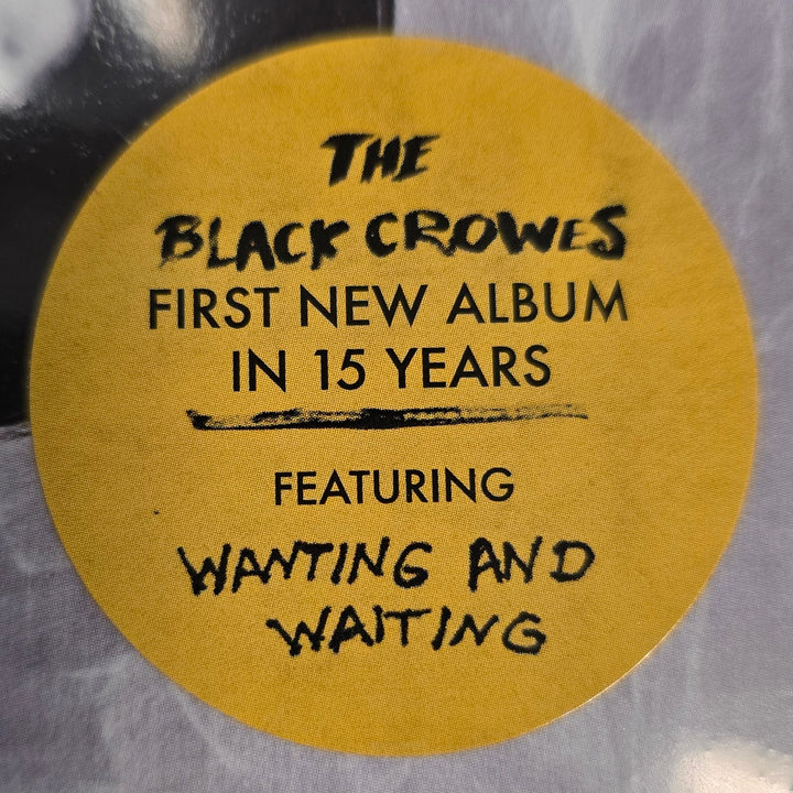 Album cover with a yellow label featuring text about The Black Crowes' new album.