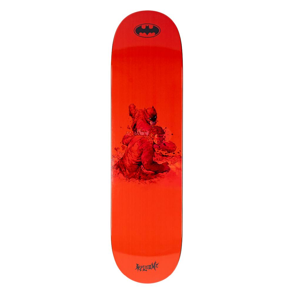 Red skateboard deck with a graphic design and Batman logo on a white background
