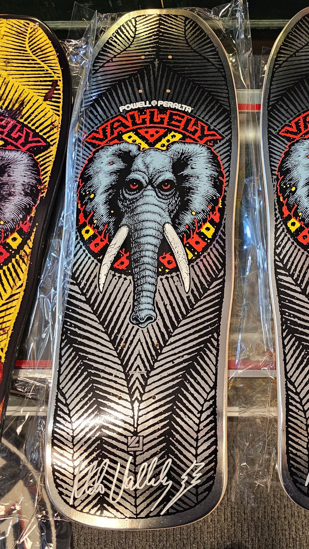 Mike vallely Signed Skateboard decks with elephant design on a reflective surface