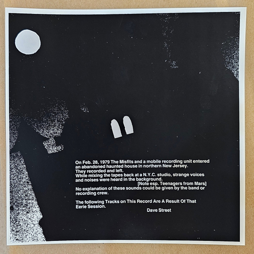 Black poster with white text and graphics on a textured beige background