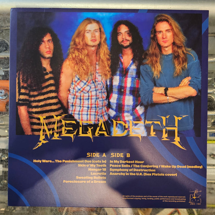Vinyl record with a cover featuring four band members on a reflective surface