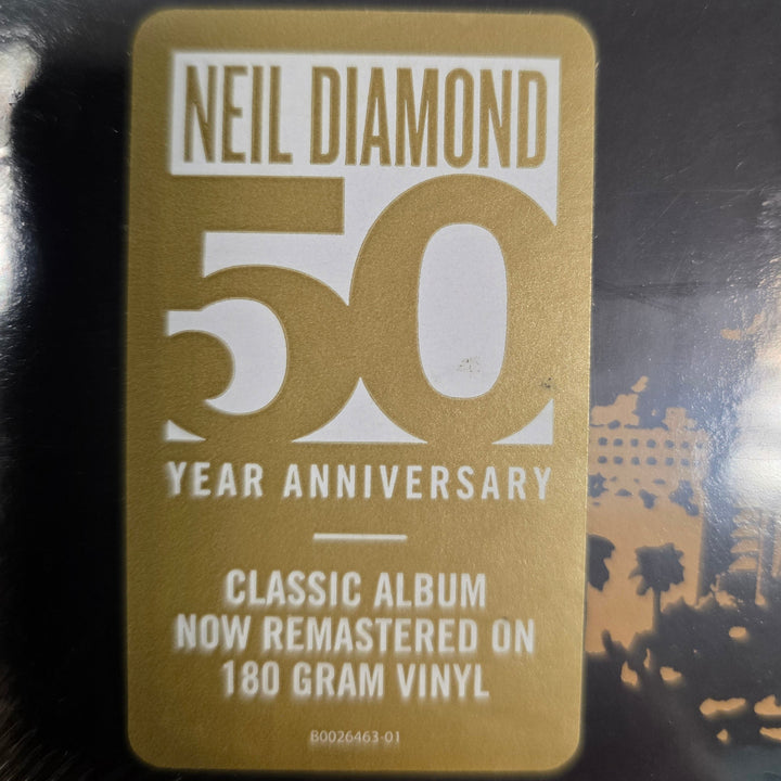 Gold 50th anniversary label on a vinyl record with 'Neil Diamond' text.