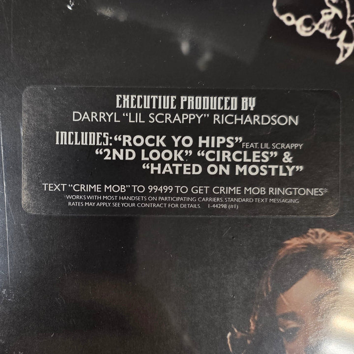 Black album cover with text and a couple embracing on a white surface with scattered papers.