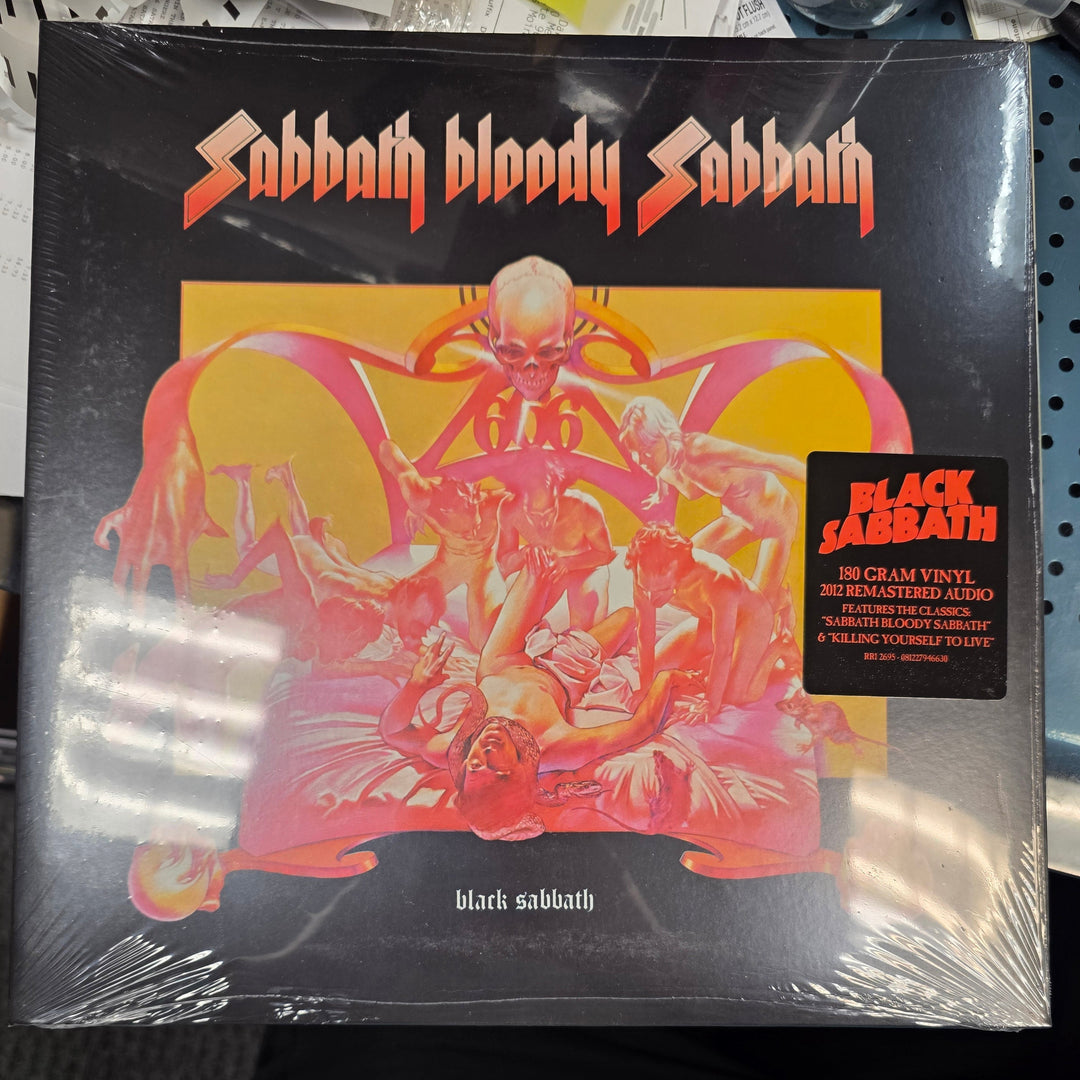 Vinyl record with a colorful cover featuring a skeleton and text, placed on a surface.