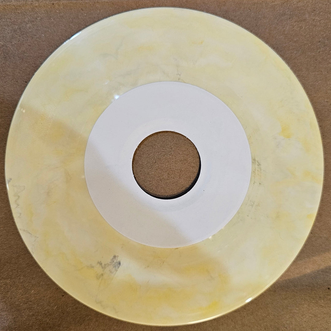 Round beige disc with a central hole on a brown background