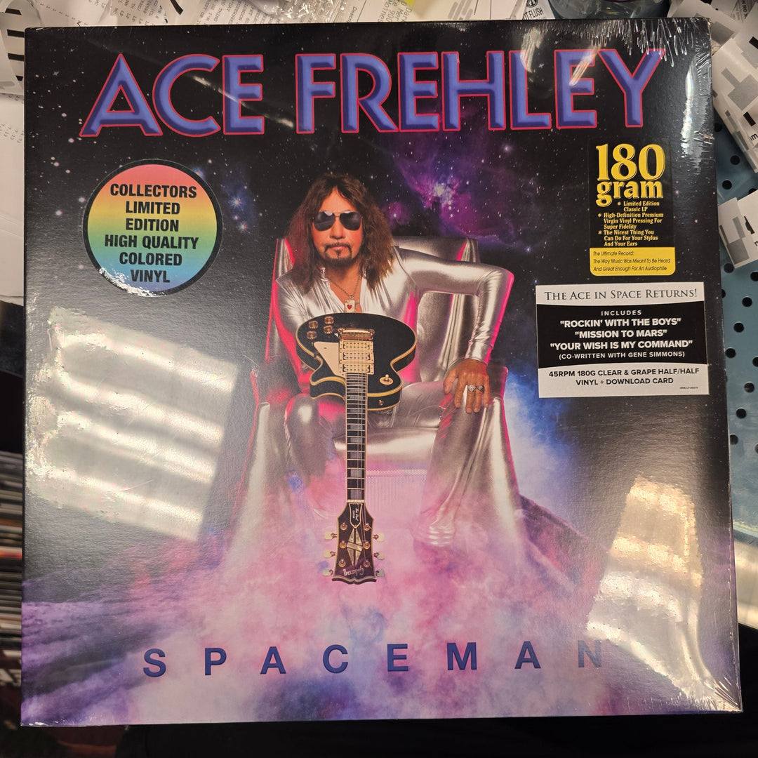 Vinyl record cover for 'Spaceman' by Ace Frehley on a surface with other items.